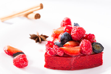cake with fresh forest berries with cinnamon and anise
