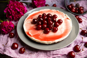 Fresh cheesecake with cherries on the rustic background. Selective focus. Shallow depth of field.