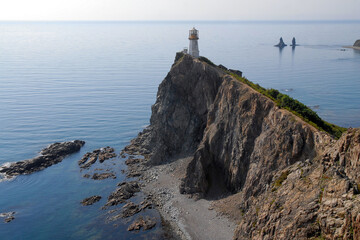 Fototapeta na wymiar View at Rudny lighthouse and Two Brothers sea stacks (rock, island). Outskirts of Rudnaya Pristan town, Primorsky Krai (Primorye), Far East, Russia.