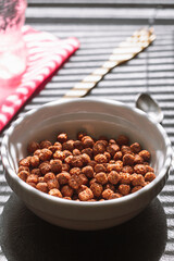 Chocolate balls cereal breakfast light through the blinds vertical orientation