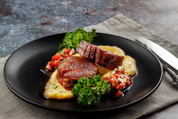 Beef medallions with tomato salsa and cream polenta