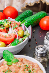 Vegetarian summer salad with beans in tomato and microgreen on the table, vertical orientation, close up