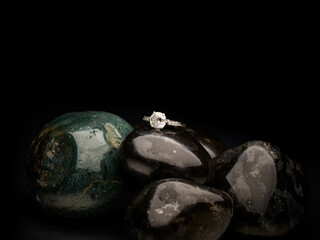 Classy silver ring close-up on top of grey stones