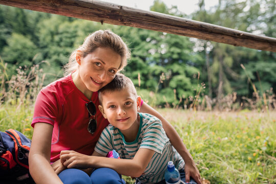 Smiling Mother And Son Taking A Break From Their Hike