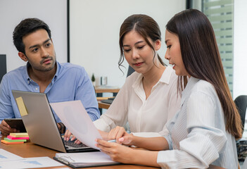 Young business group explaining new business ideas to peers. Business people discussing in meeting...
