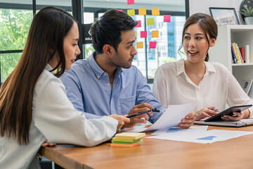 Young business group explaining new business ideas to peers. Business people discussing in meeting room.