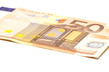 A fifty Euro note on a white background. Macro. Selective focus.