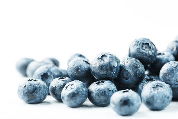 Blueberries are scattered on a white background. Free space, isolate. Studio light.