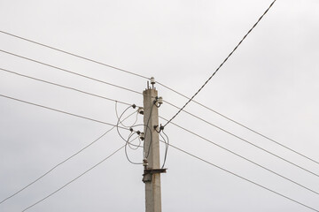 Electricity pole with power wires line in a cloudy day