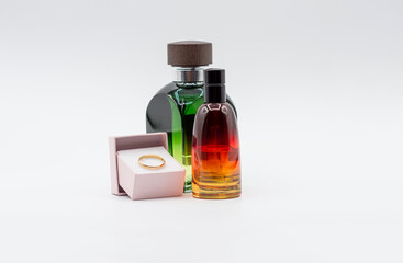 TWO BOTTLES OF PERFUME AND A WEDDING ENGAGEMENT RING