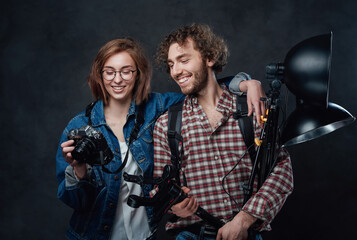 Couple of photographers emotionally discuss the resulting pictures after a photo session in the studio