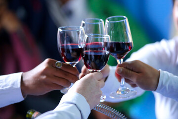 four glasses of champagne in hands