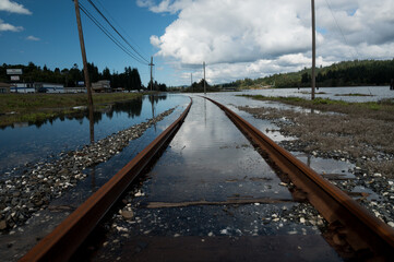 Rusty Train tracks in Coos Bay, Oregon under water. 