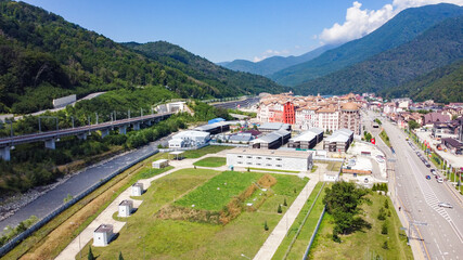 Infrastructure of a modern city. Aerial view of beautiful futuristic modern water intake pumping wells against the background of mountains and peaks. Sochi, Russia.