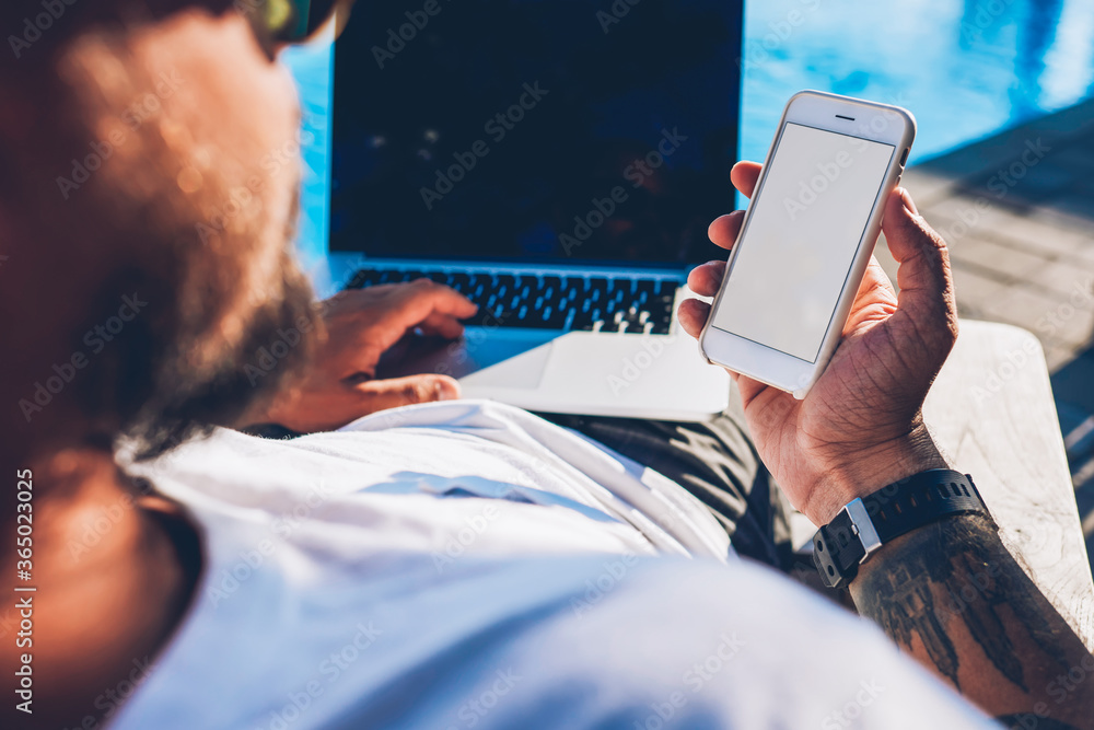 Poster croped image of man tourist holding modern smartphone with blank copy space screen for your advertis