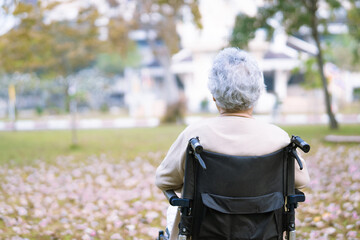 Asian senior or elderly old lady woman patient on wheelchair in park, healthy strong medical concept.