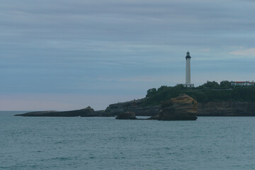 The architecture of French Biarritz. Lighthouse on the shore. Cloudy sunset. Touristic concept.