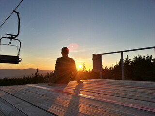 silhouette of a man on a bench