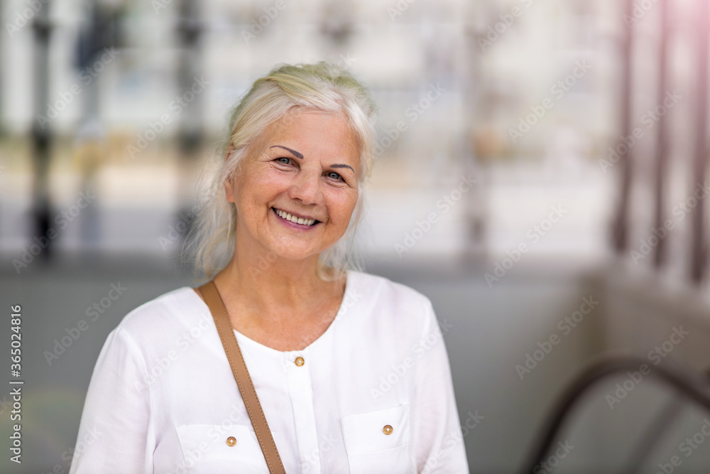 Canvas Prints Portrait of senior woman smiling in the city
