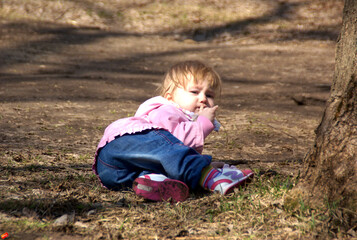 little girl sitting on the ground