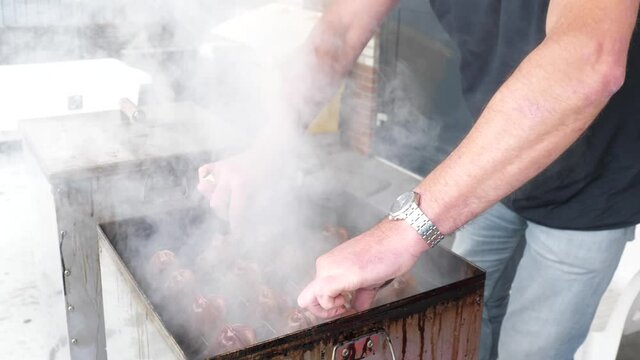 Smoking Poon fish lifting of the lit of the smoker