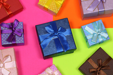 Gift on a multicolored background. Surprise in a festive package.