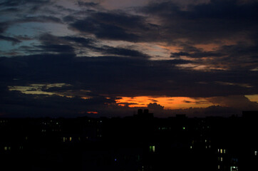 landscape shot of a cloudy sky at sunset with pink and orange clouds, in the county of Bangladesh. sunset in the city with shadows of buildings. 