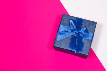 Gift on a multicolored background. Surprise in a festive package.