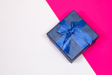 Gift on a multicolored background. Surprise in a festive package.
