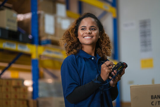 industrial worker in factory, worker woman smiling working in warehouse stock checking. happy work black girl in factory