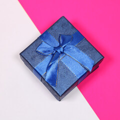 Gift on a multicolored background. Surprise in a festive package.