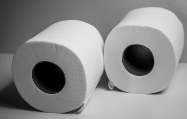 Closeup shot of 2 toilet rolls on white background