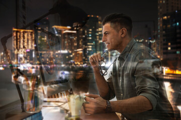 Double exposure of male designer and night cityscape