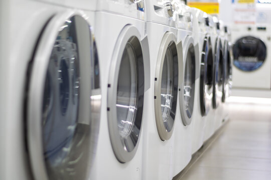 A Row Of Washing Machines In The Store.