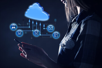 Cloud computing and storage concept. Woman using smartphone on dark background, closeup