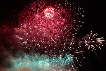Fireworks for the holiday from different colorful explosions in the night sky
