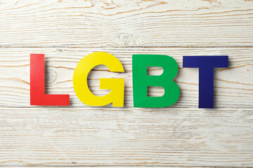 Colored letters LGBT on white wooden background