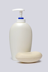 Fototapeta na wymiar piece of soap and bottle of liquid soap over light grey backgound with clipping path