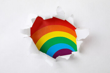 Hole in the paper with LGBT colors background