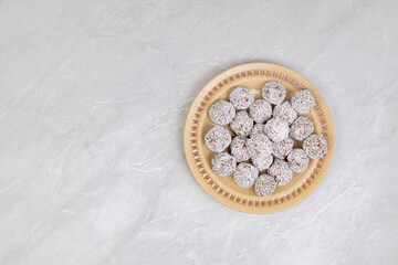 Fototapeta na wymiar Energy Balls cookies with grated coconut served on the plate
