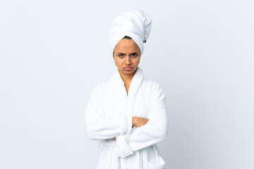 Young woman in bathrobe over isolated white background feeling upset