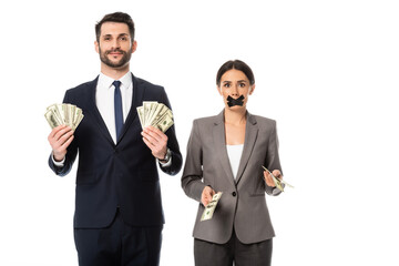 happy businessman holding dollars near businesswoman with duct tape on mouth isolated on white, gender inequality concept