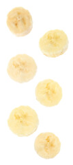 Set with delicious ripe banana pieces falling on white background