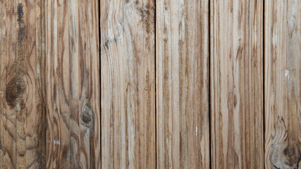 Vertical brown wooden planks. Wood covered in paint and dust. Wooden vintage background.