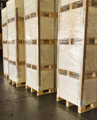 Shipment cartons box on pallets and wooden case on forklift in interior warehouse cargo for export and sorting goods in freight logistics and transportation industrial