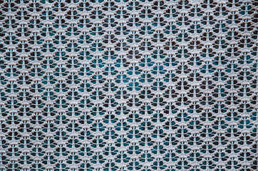 White curtain with a pattern on the window.