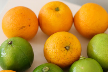 Obraz na płótnie Canvas Beautiful lemons and oranges arranged on a table. A fruit rich in vitamin c.
