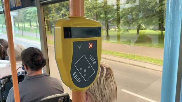 Ticket validator faulty, card reader in public transport. Device scanning of public transport cards to pay for riding. Red lights signal in the form of a cross. Device error 4k
