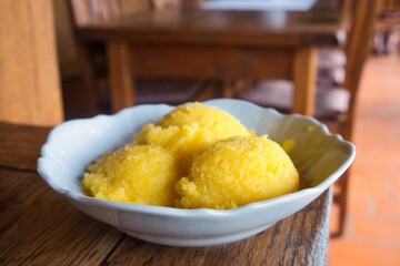 Polenta is a dish of boiled cornmeal that was made from maize or buckwheat. It may be served as a hot porridge
