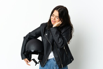 Woman holding a motorcycle helmet isolated on white background frustrated and covering ears